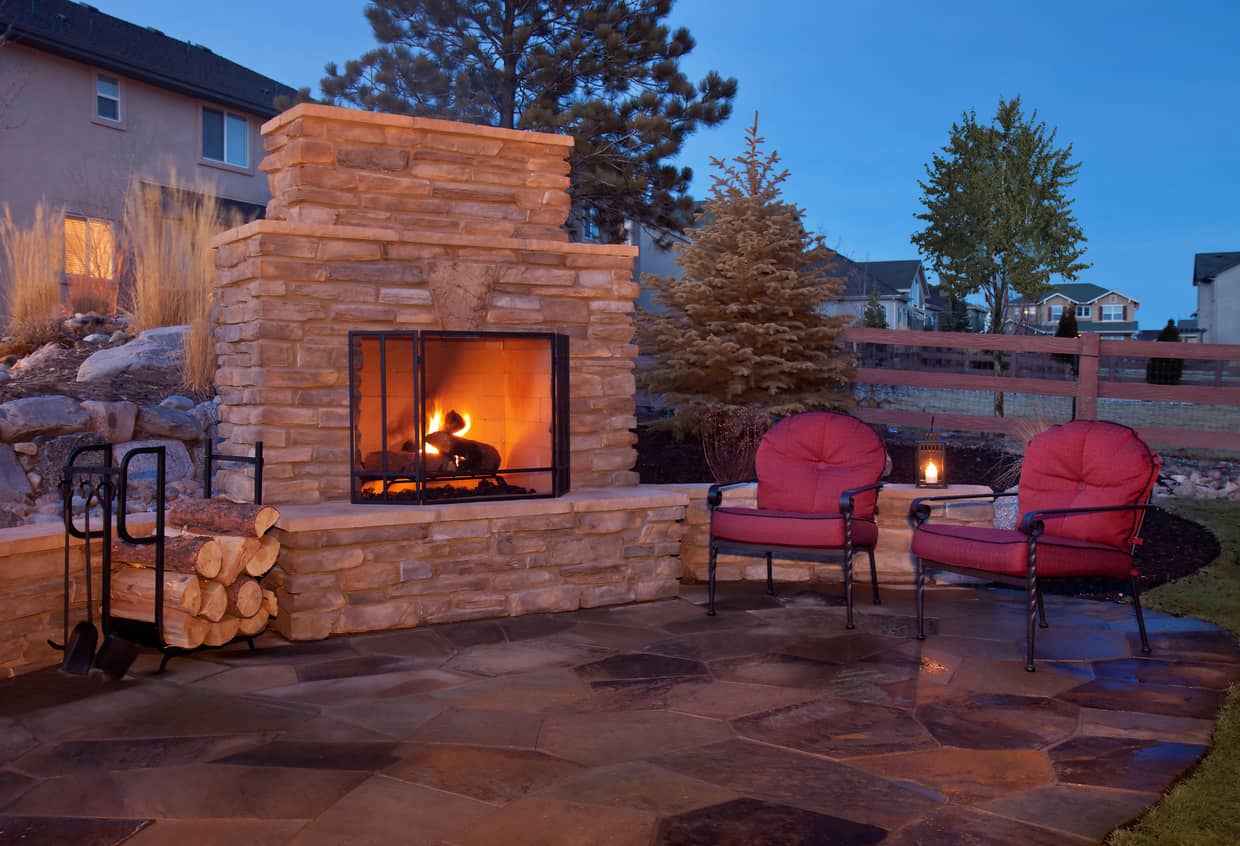 Backyard patio with a fireplace.